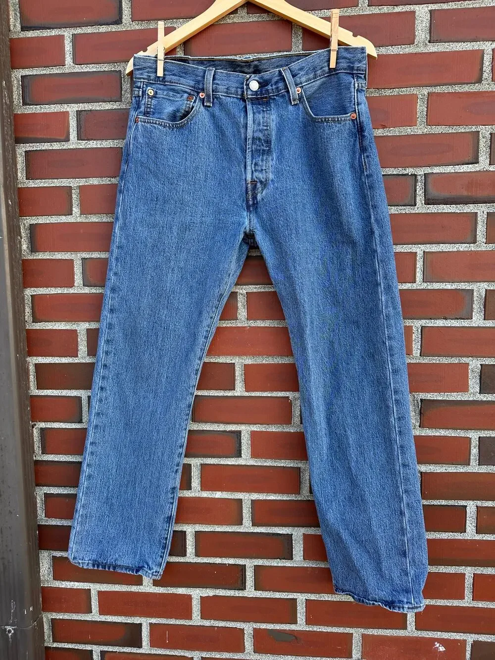 Vintage Levi's 501 button-fly jeans with Y2K's red batwing label